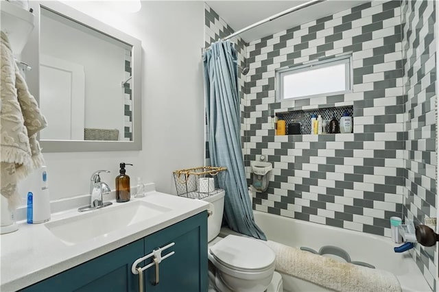 full bath with vanity, shower / tub combo, and toilet