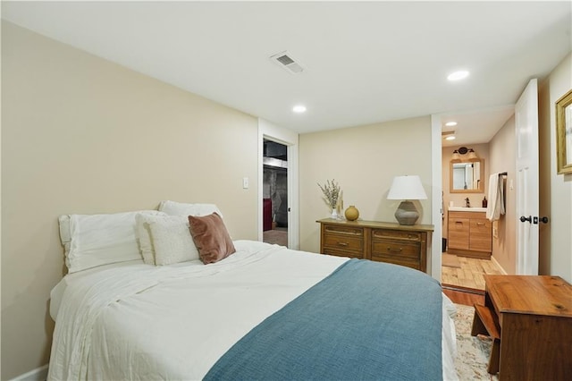 bedroom with recessed lighting, baseboards, visible vents, and wood finished floors