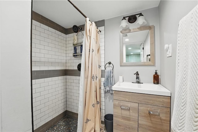 bathroom featuring vanity and tiled shower