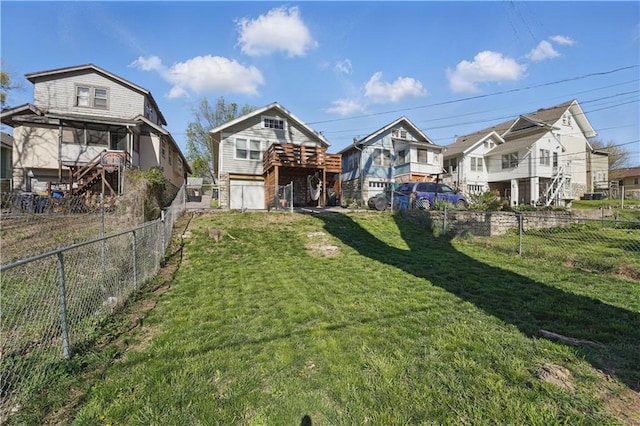 back of property featuring a lawn, a fenced backyard, and a residential view