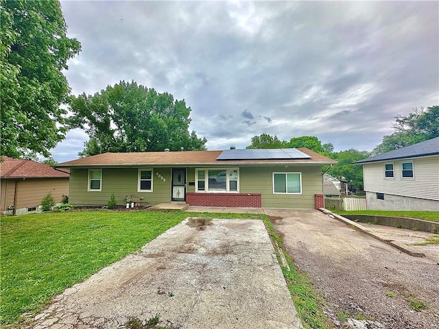 4322 Everett Ave, Kansas City, KS 66102 - ranch-style house featuring roof mounted solar panels and covered porch