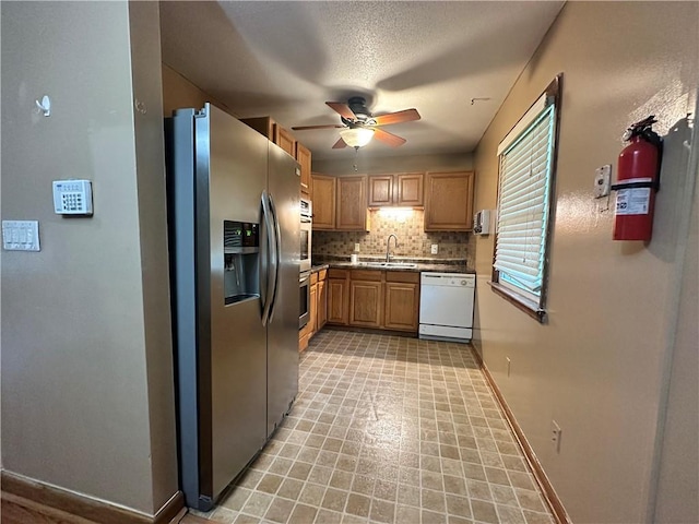 4322 Everett Ave, Kansas City, KS 66102 - kitchen featuring stainless steel appliances, a ceiling fan, tasteful backsplash, a sink, and baseboards