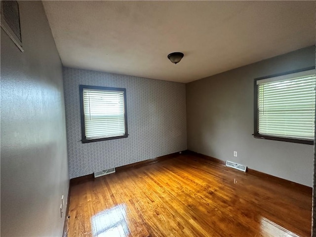 4322 Everett Ave, Kansas City, KS 66102 - unfurnished room featuring light wood-style flooring, wallpapered walls, and baseboards