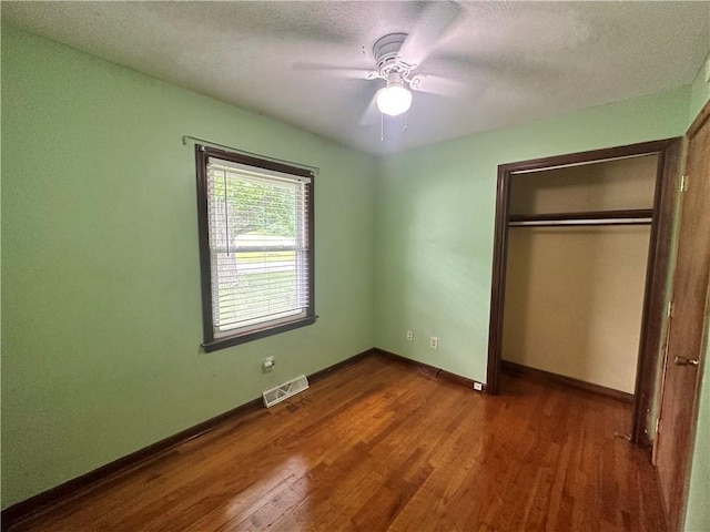 4322 Everett Ave, Kansas City, KS 66102 - unfurnished bedroom featuring wood finished floors, a closet, baseboards, a textured ceiling, and ceiling fan