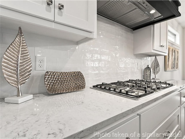 11600 S Millridge St, Olathe, KS 66061 - kitchen with custom range hood, stainless steel gas cooktop, tasteful backsplash, white cabinetry, and light stone countertops