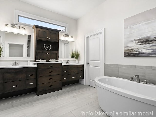 11600 S Millridge St, Olathe, KS 66061 - bathroom with double vanity, a freestanding tub, and plenty of natural light