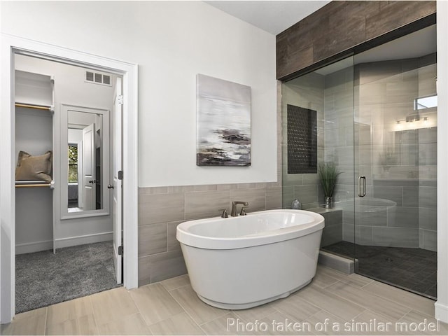 11600 S Millridge St, Olathe, KS 66061 - full bathroom with tile walls, a shower stall, and a freestanding bath