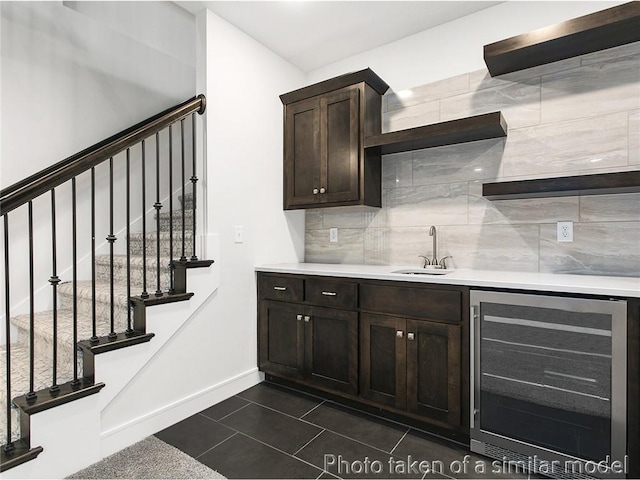 11600 S Millridge St, Olathe, KS 66061 - indoor wet bar featuring beverage cooler, baseboards, tasteful backsplash, stairs, and dark tile patterned floors