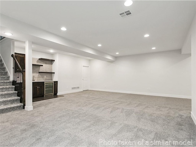 11600 S Millridge St, Olathe, KS 66061 - finished below grade area with carpet floors, beverage cooler, recessed lighting, stairs, and baseboards