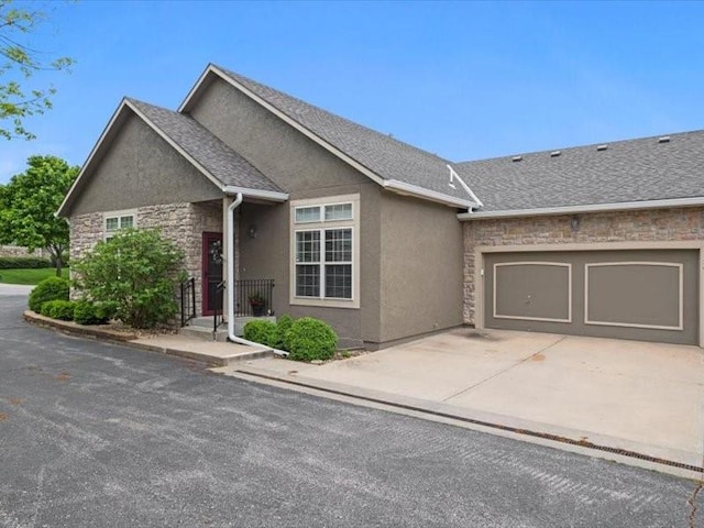 11179 S Summit St, Olathe, KS 66062 - view of front of property featuring a shingled roof, stone siding, a garage, stucco siding, and driveway