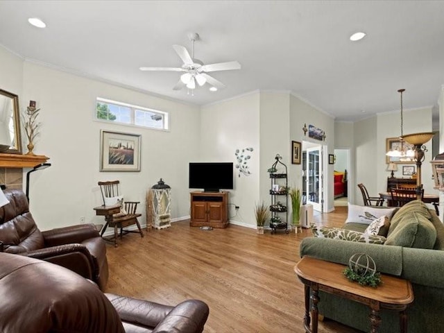 11179 S Summit St, Olathe, KS 66062 - living room featuring crown molding, ceiling fan with notable chandelier, and wood finished floors