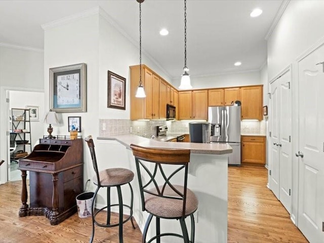 11179 S Summit St, Olathe, KS 66062 - kitchen featuring ornamental molding, backsplash, a breakfast bar, and stainless steel appliances