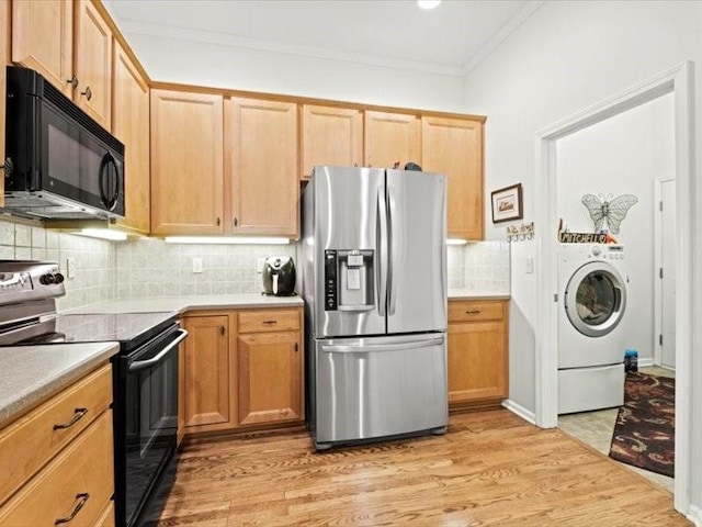 11179 S Summit St, Olathe, KS 66062 - kitchen with electric range, black microwave, stainless steel fridge, light wood-style floors, and washer / clothes dryer