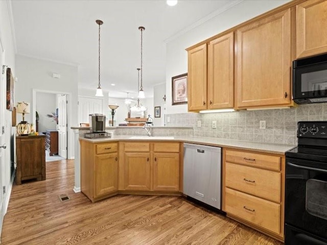 11179 S Summit St, Olathe, KS 66062 - kitchen featuring a sink, light wood-style floors, light countertops, a peninsula, and black appliances