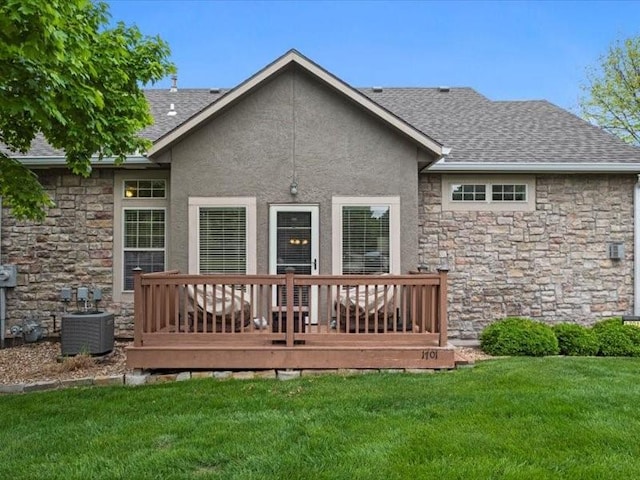 11179 S Summit St, Olathe, KS 66062 - back of property with a shingled roof, stone siding, a deck, cooling unit, and a lawn