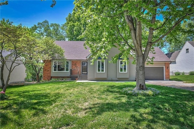 ranch-style home with driveway, roof with shingles, brick siding, a front lawn, and an attached garage