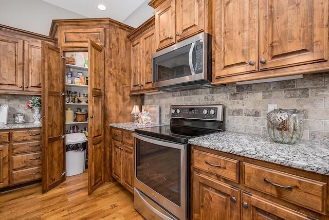 kitchen featuring brown cabinetry and stainless steel appliances