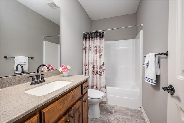 bathroom with visible vents, vanity, toilet, baseboards, and shower / bath combo