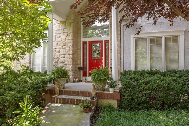 26266 W 110th Ter, Olathe, KS 66061 - doorway to property featuring a porch and stone siding
