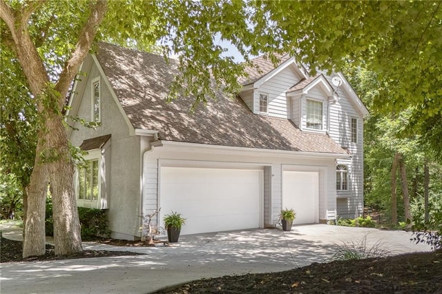 26266 W 110th Ter, Olathe, KS 66061 - view of front of house with a garage, concrete driveway, and roof with shingles
