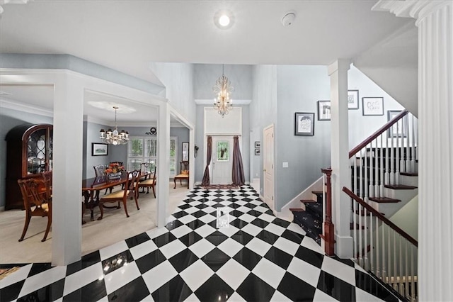 26266 W 110th Ter, Olathe, KS 66061 - foyer entrance featuring a chandelier, ornate columns, stairs, crown molding, and recessed lighting
