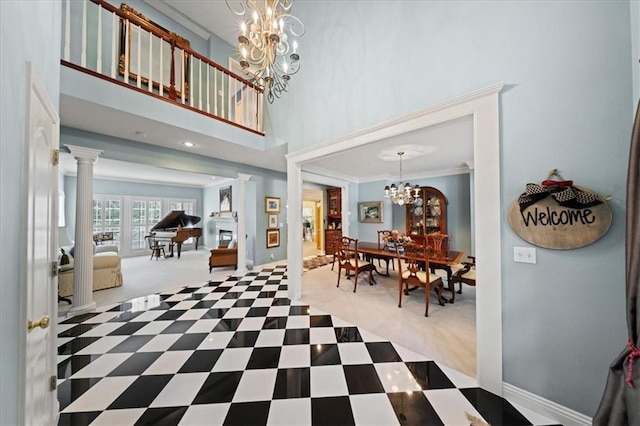26266 W 110th Ter, Olathe, KS 66061 - foyer featuring a chandelier, decorative columns, carpet, a towering ceiling, and crown molding
