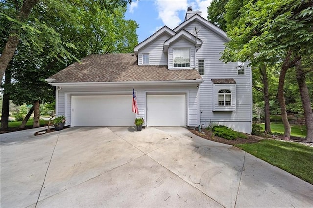 26266 W 110th Ter, Olathe, KS 66061 - traditional home featuring driveway, a chimney, a garage, and roof with shingles