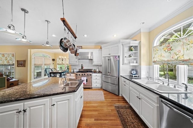 26266 W 110th Ter, Olathe, KS 66061 - kitchen with high quality appliances, wall chimney exhaust hood, ornamental molding, white cabinetry, and tasteful backsplash