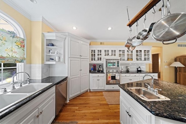 26266 W 110th Ter, Olathe, KS 66061 - kitchen with stainless steel appliances, crown molding, white cabinets, backsplash, and light wood finished floors