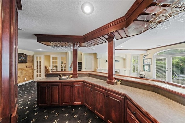 26266 W 110th Ter, Olathe, KS 66061 - bar with french doors, decorative columns, carpet, and a textured ceiling