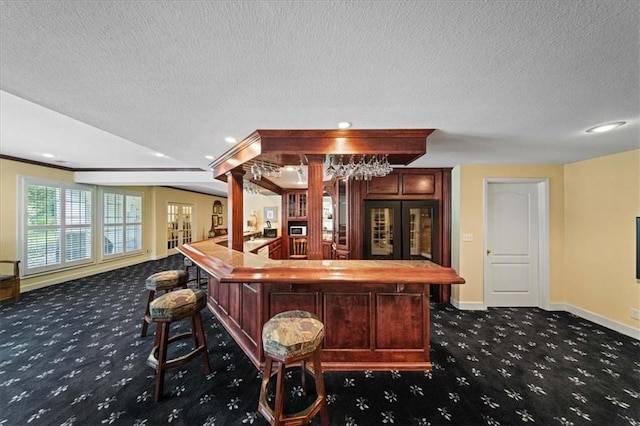 26266 W 110th Ter, Olathe, KS 66061 - indoor bar featuring dark carpet, a textured ceiling, recessed lighting, and refrigerator