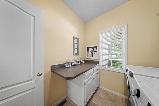 26266 W 110th Ter, Olathe, KS 66061 - laundry room featuring washer and clothes dryer, cabinet space, and light tile patterned floors