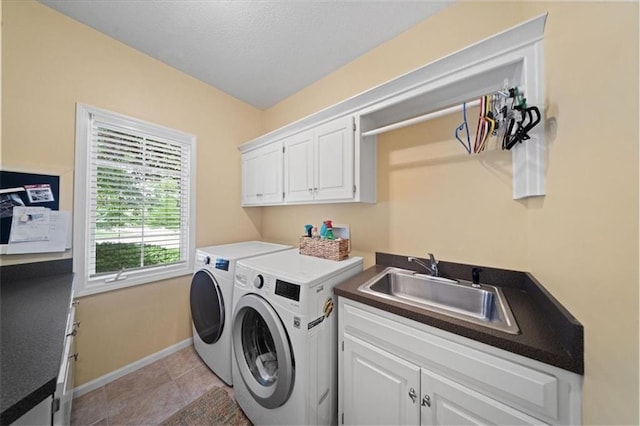 26266 W 110th Ter, Olathe, KS 66061 - laundry area featuring washer and clothes dryer, cabinet space, and light tile patterned floors