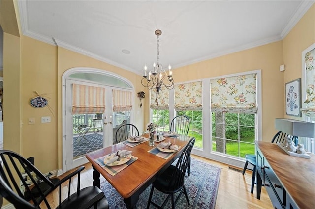 26266 W 110th Ter, Olathe, KS 66061 - dining area with a chandelier, light wood-style floors, and crown molding