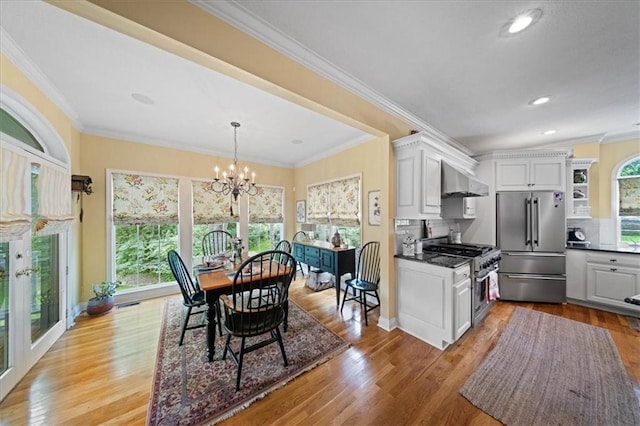 26266 W 110th Ter, Olathe, KS 66061 - dining space featuring a chandelier, light wood finished floors, recessed lighting, and crown molding