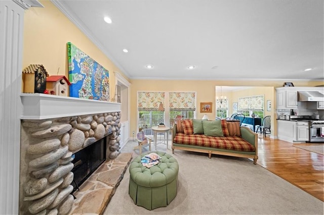 26266 W 110th Ter, Olathe, KS 66061 - living room featuring ornamental molding, recessed lighting, a stone fireplace, and light wood-style floors