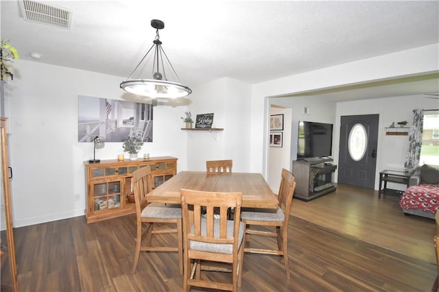 5233 N Garfield Ave, Kansas City, MO 64118 - dining room featuring wood finished floors, a chandelier, and baseboards