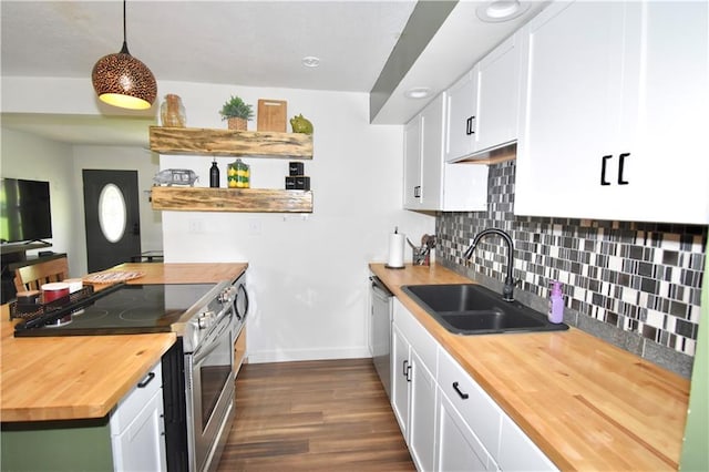 5233 N Garfield Ave, Kansas City, MO 64118 - kitchen featuring wood counters, appliances with stainless steel finishes, a sink, baseboards, and dark wood-style floors