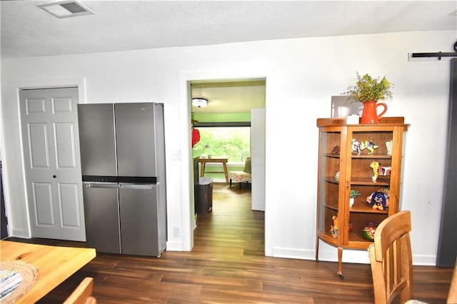 5233 N Garfield Ave, Kansas City, MO 64118 - kitchen featuring freestanding refrigerator, dark wood-style floors, and baseboards