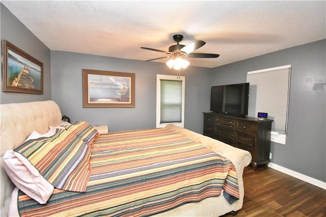 5233 N Garfield Ave, Kansas City, MO 64118 - bedroom featuring dark wood finished floors, baseboards, and ceiling fan