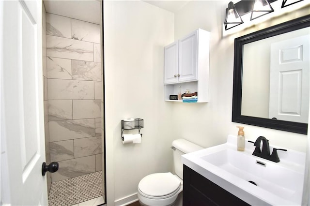 5233 N Garfield Ave, Kansas City, MO 64118 - full bathroom with toilet, a tile shower, and vanity