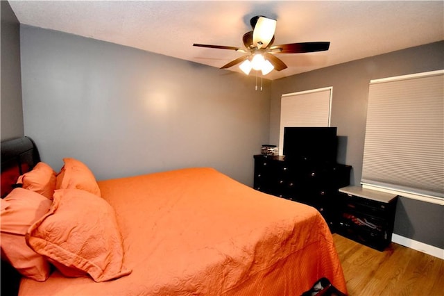 5233 N Garfield Ave, Kansas City, MO 64118 - bedroom featuring wood finished floors, baseboards, and ceiling fan