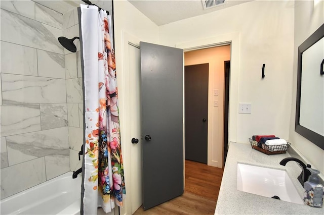 5233 N Garfield Ave, Kansas City, MO 64118 - bathroom with shower / bath combo, wood finished floors, and vanity