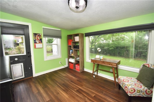 5233 N Garfield Ave, Kansas City, MO 64118 - sitting room with vaulted ceiling, a textured ceiling, wood finished floors, and baseboards