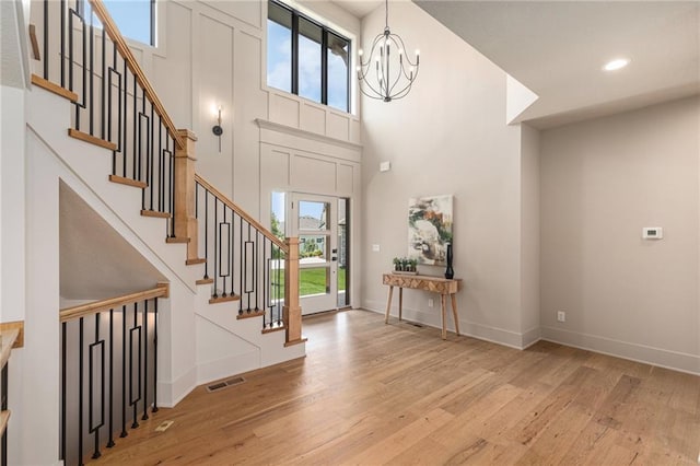 2314 SW Serena Pl, Lees Summit, MO 64082 - entryway with light wood finished floors, stairway, healthy amount of natural light, a high ceiling, and recessed lighting