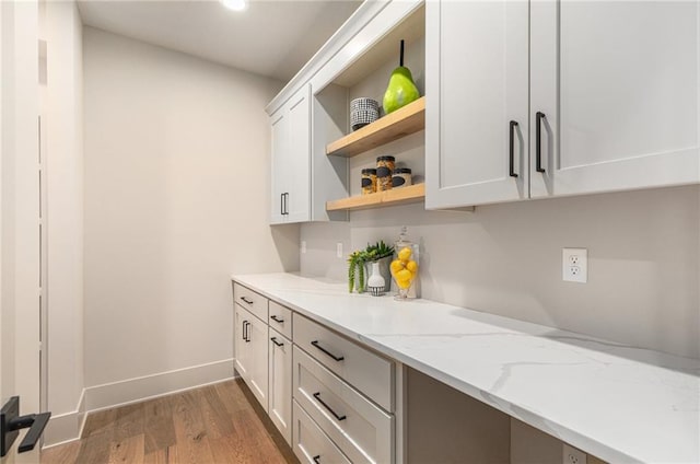 2314 SW Serena Pl, Lees Summit, MO 64082 - kitchen featuring open shelves, wood finished floors, white cabinets, light stone countertops, and recessed lighting