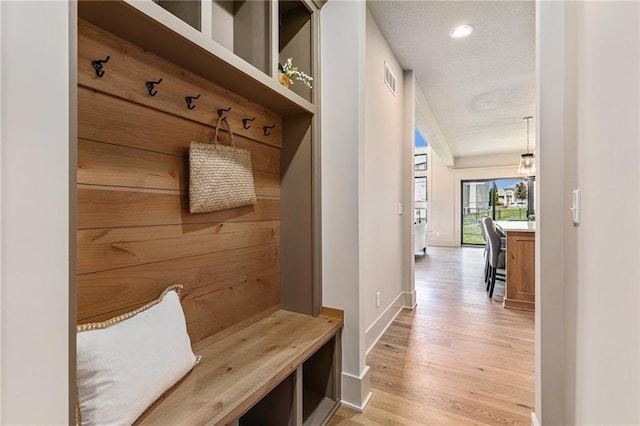 2314 SW Serena Pl, Lees Summit, MO 64082 - mudroom featuring light wood finished floors, a textured ceiling, and recessed lighting