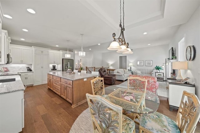 811 W Shawhan Pkwy, Lees Summit, MO 64086 - kitchen with open floor plan, white cabinets, dark wood-style floors, appliances with stainless steel finishes, and recessed lighting