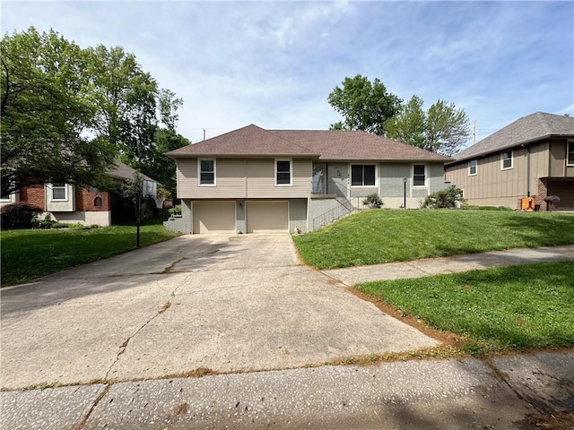 4024 NE 59th Ter, Gladstone, MO 64119 - view of front facade with an attached garage, a front lawn, and driveway