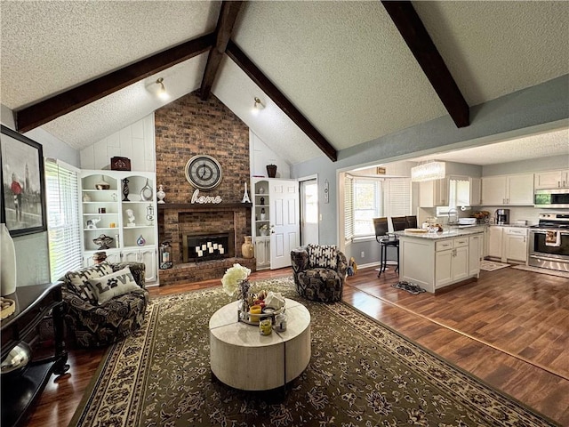 4024 NE 59th Ter, Gladstone, MO 64119 - living area with dark wood-type flooring, a textured ceiling, a brick fireplace, and vaulted ceiling with beams